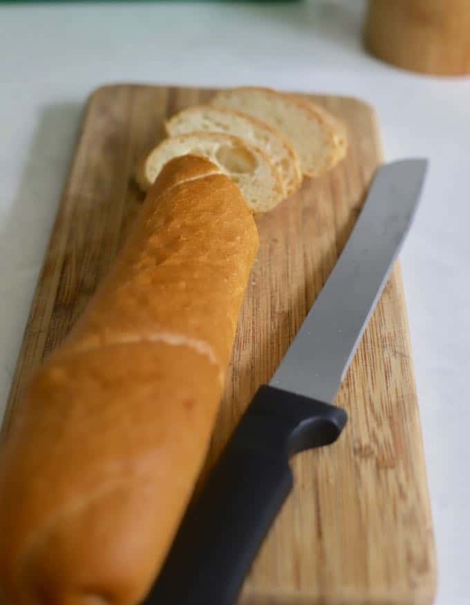 A loaf of french bread sliced to make Baked Mushroom Casserole.