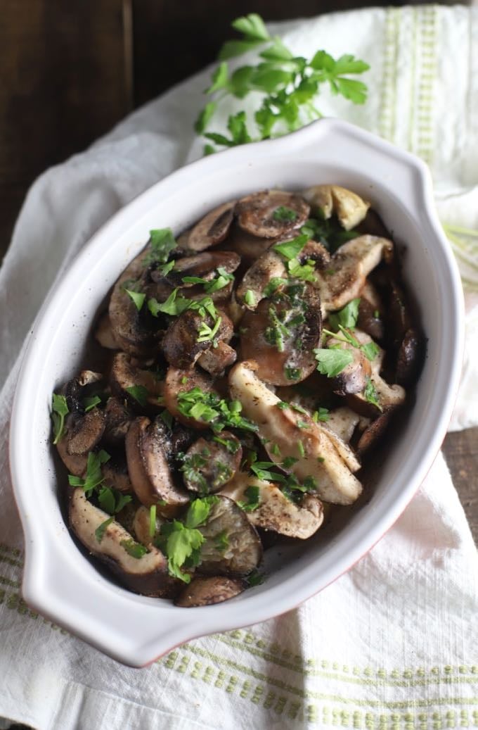 Baked Mushroom Casserole garnished with parsley in a white baking dish.