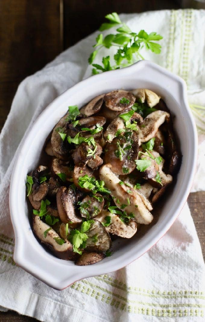 Baked Mushroom Casserole in a white baking dish garnished with parsley.