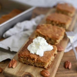 A dollop of whipped cream on a piece of Georgia Cornbread Cake.