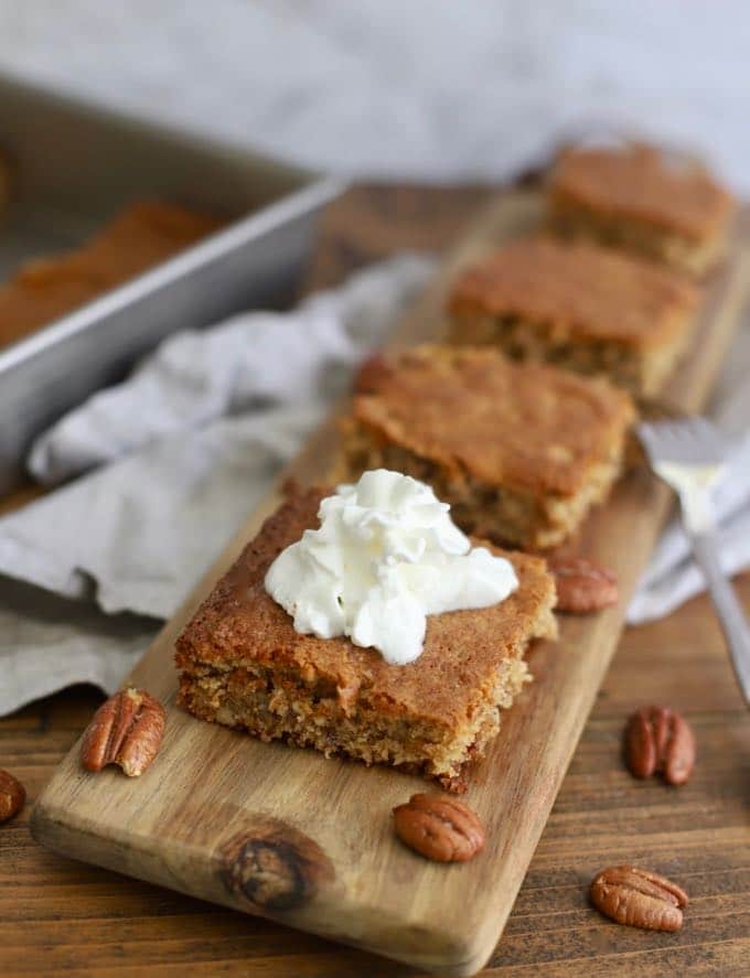 A dollop of whipped cream on a piece of Georgia Cornbread Cake.