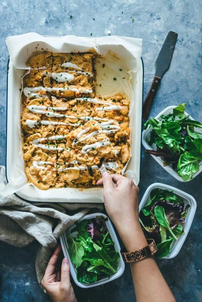 Whole 30 Baked Buffalo Chicken Casserole in a white baking dish with salad.