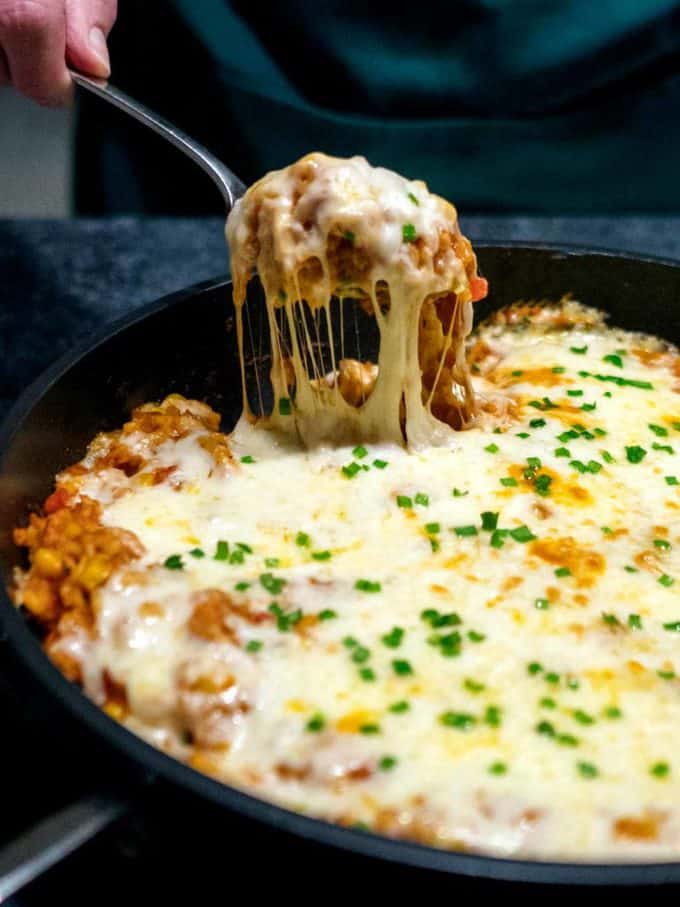 Chicken and rice casserole in a black cast iron pan.