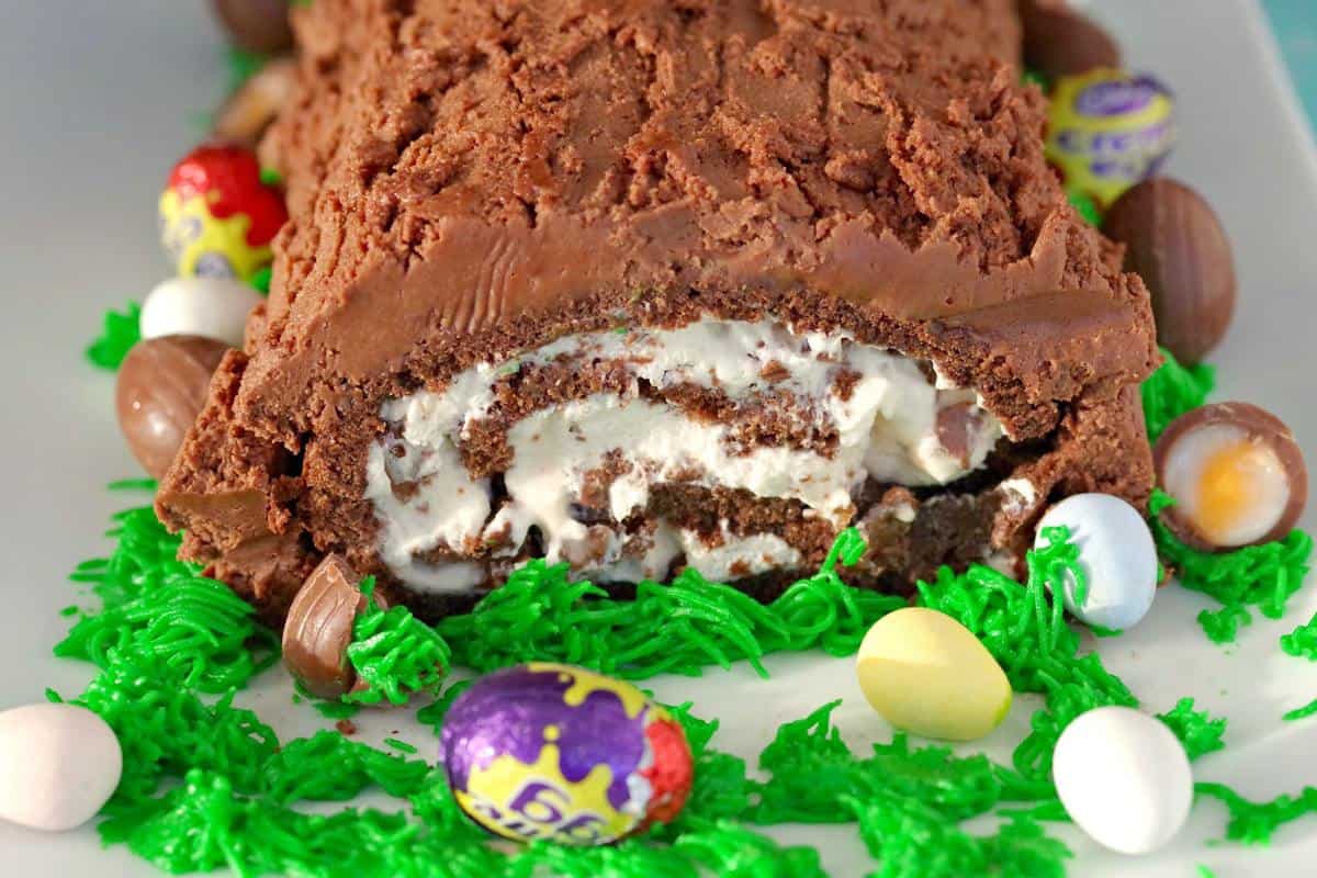 An Easter themed Creme Egg Swiss Roll Cake with Easter candy. 