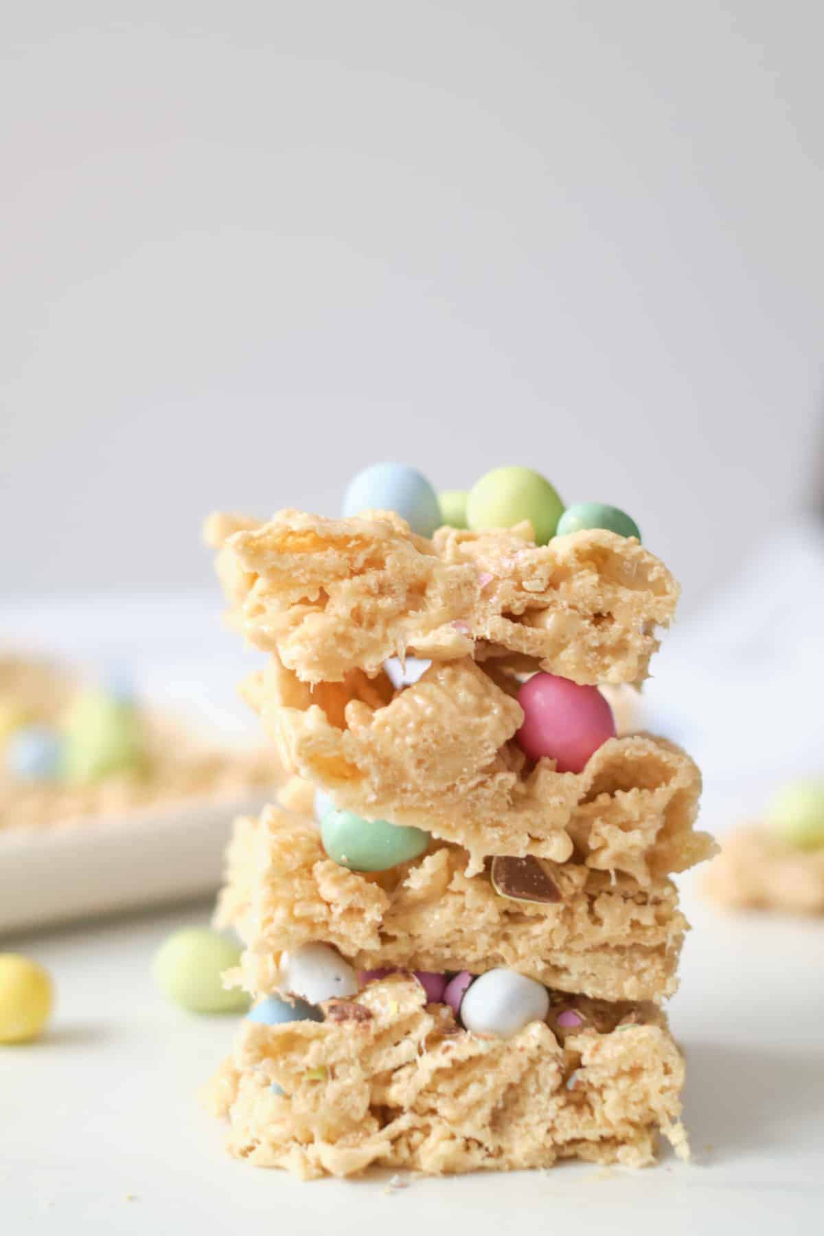 Three Easter cookie bars made with Chex cereal topped with candy. 