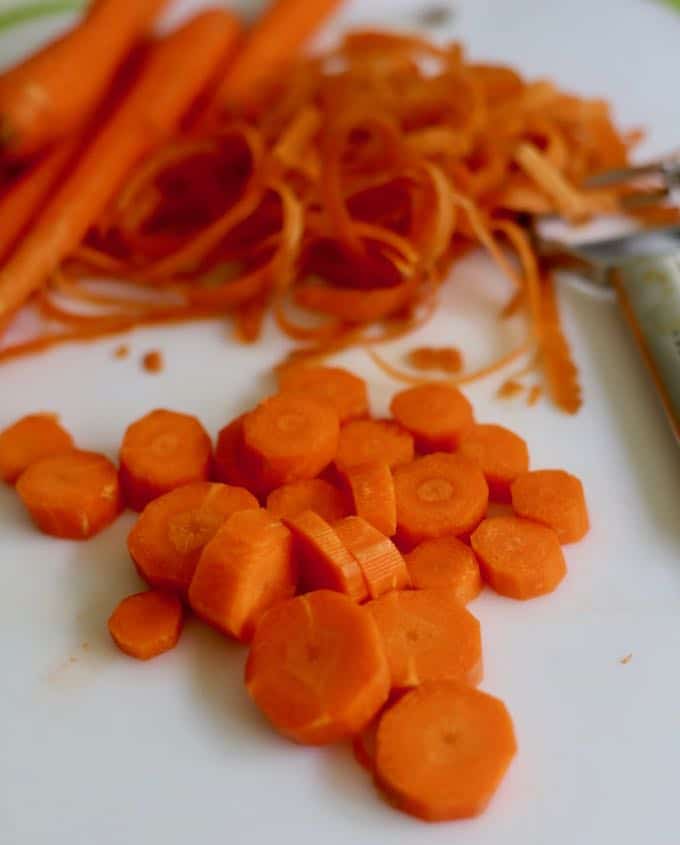 Sliced carrots on a cutting board.