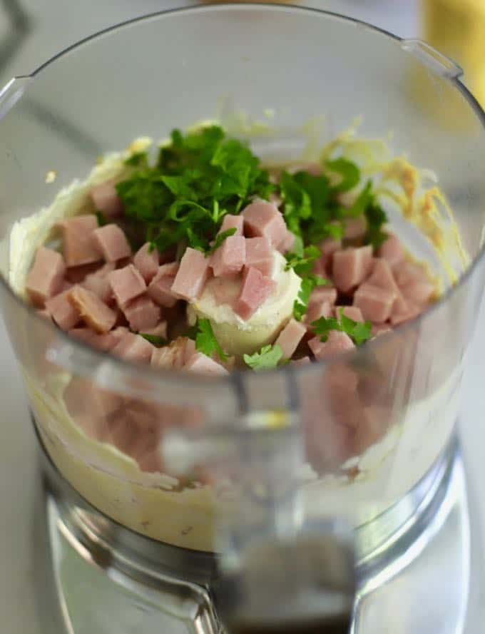 Ham, parsley, and scallions in a food processor.