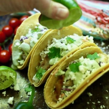 Squeezing lime juice over grilled fish tacos.