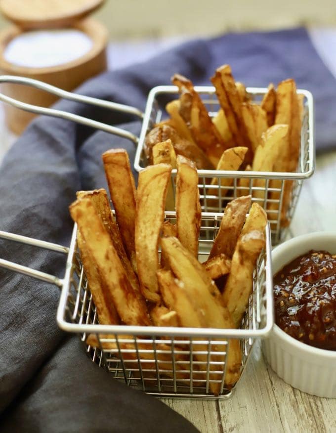Two wire baskets with homemade french fries.