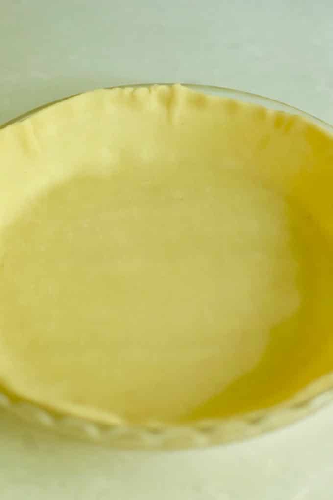 An unbaked pie crust in a pie plate ready for filling.