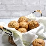 Zucchini Banana Muffins in a basket on a kitchen counter.