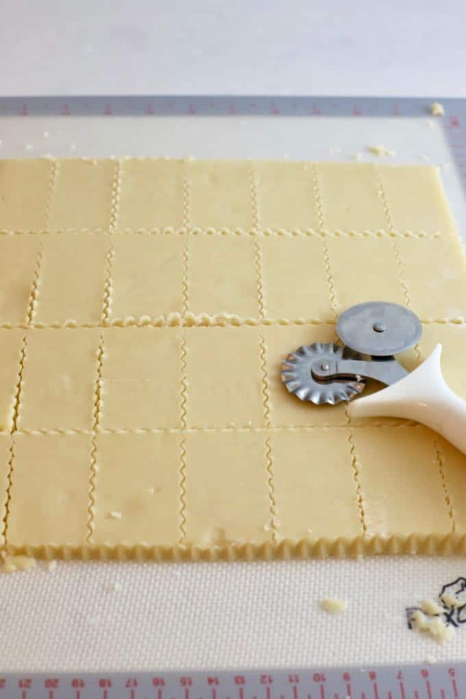 Using a pastry cutter to cut out lemon shortbread cookies.