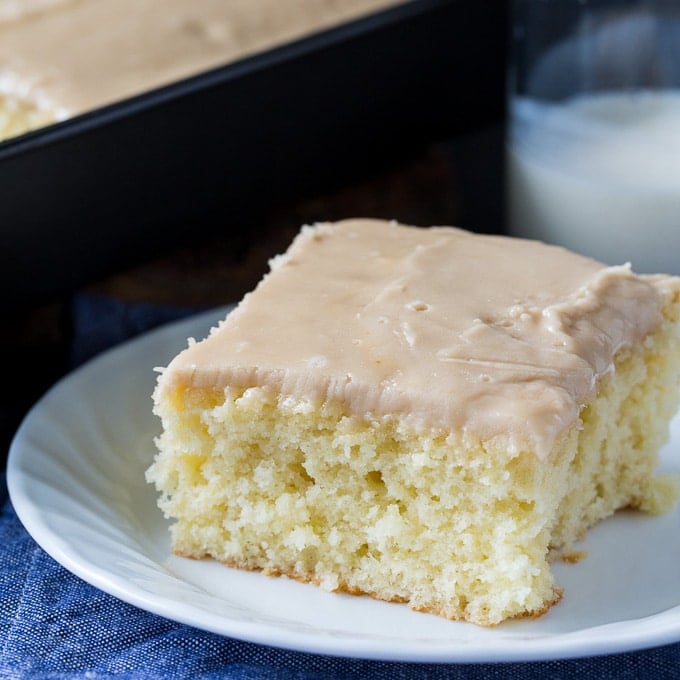 A piece of Buttermilk Sheet Cake with Caramel Icing on a plate.