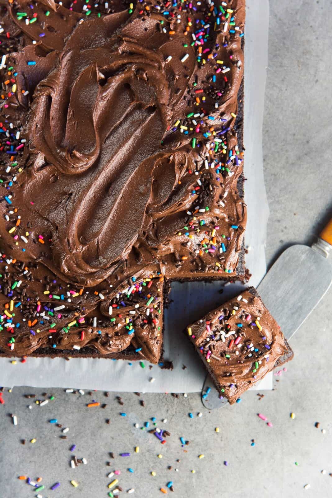 Cutting a square of fudge chocolate sheet cake.