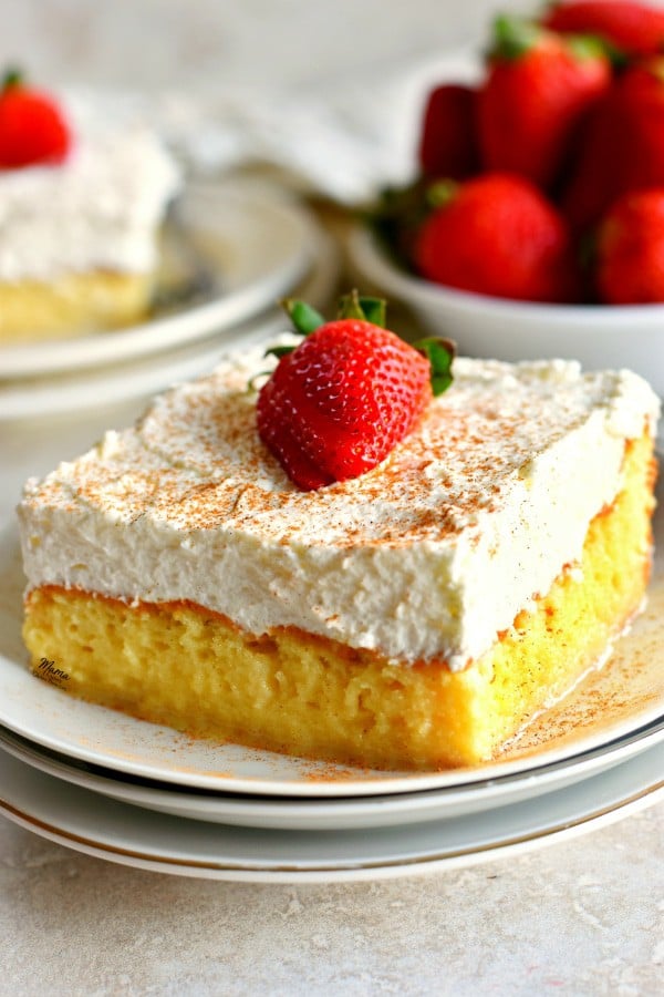 Gluten Free Tres Leches Cake with a raspberry on top.