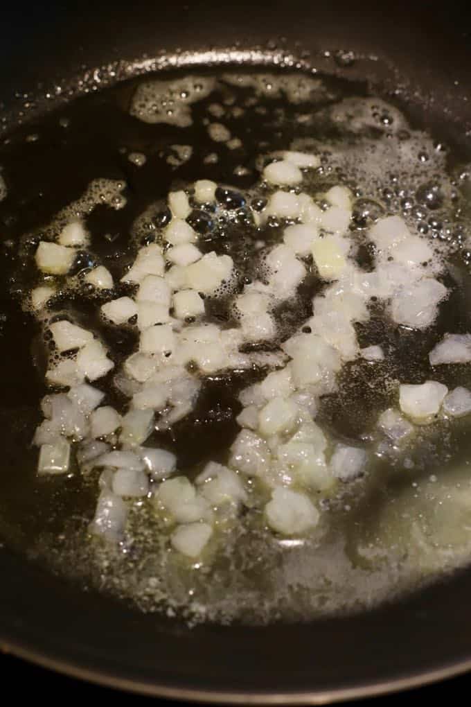 Onion cooking in butter in a skillet. 