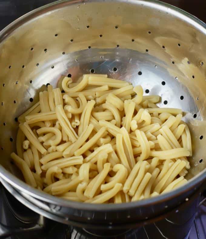 Cooked pasta in a colander.