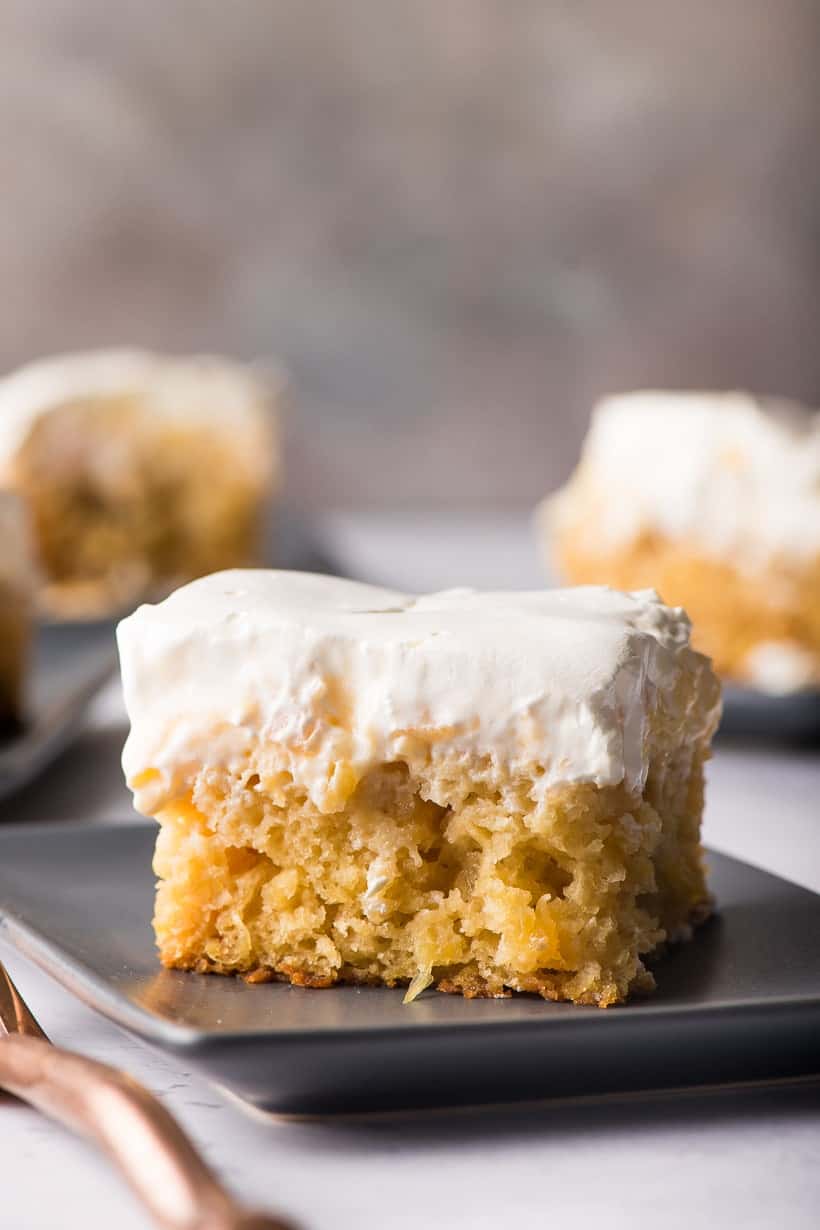 A slice of pineapple sunshine cake on a plate.