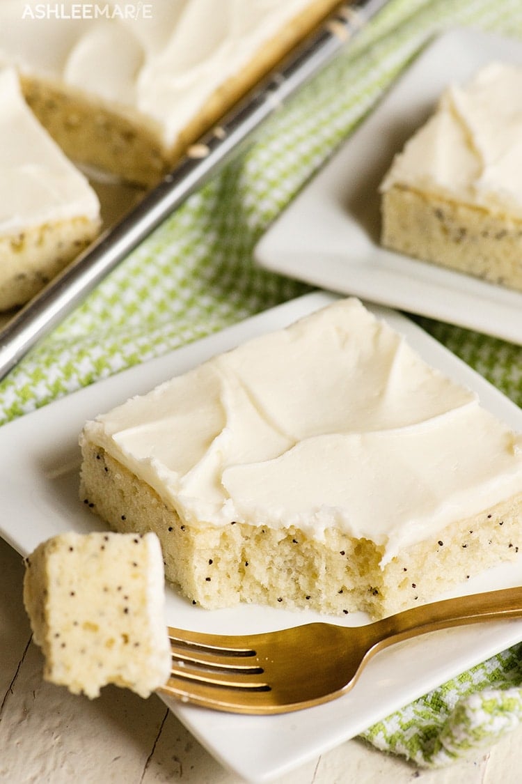 Poppy seed almond sheet cake on a white plate.