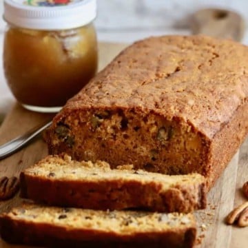 A loaf of sweet potato bread with slices cut.