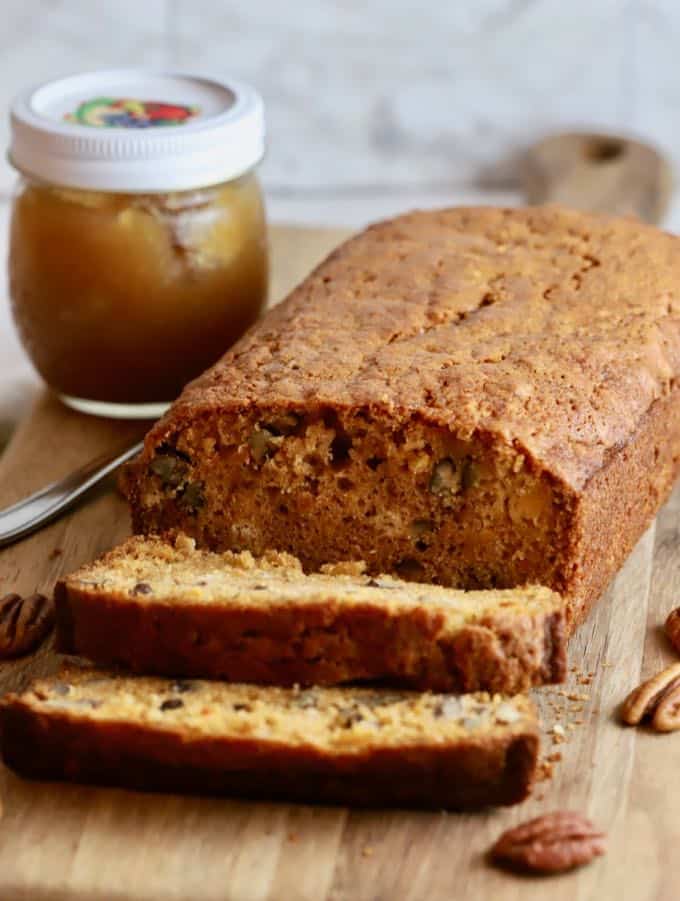 A loaf of sweet potato bread with slices cut.