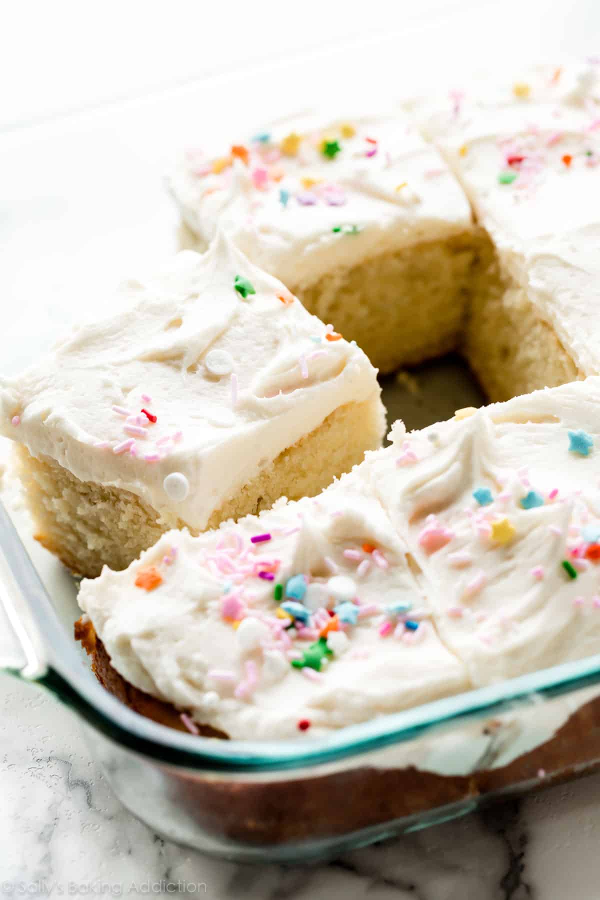 Vanilla Sheet Cake with Buttercream Icing topped with multi-color sprinkles.