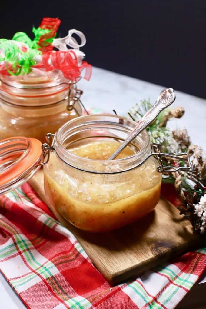 A jar of jezebel sauce with a spoon. 