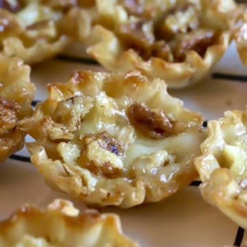 Close up shot of a bourbon pecan brie bite appetizer.