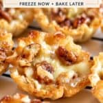 Bourbon pecan brie bites in crisp phyllo cups, filled with melted brie and topped with pecans.