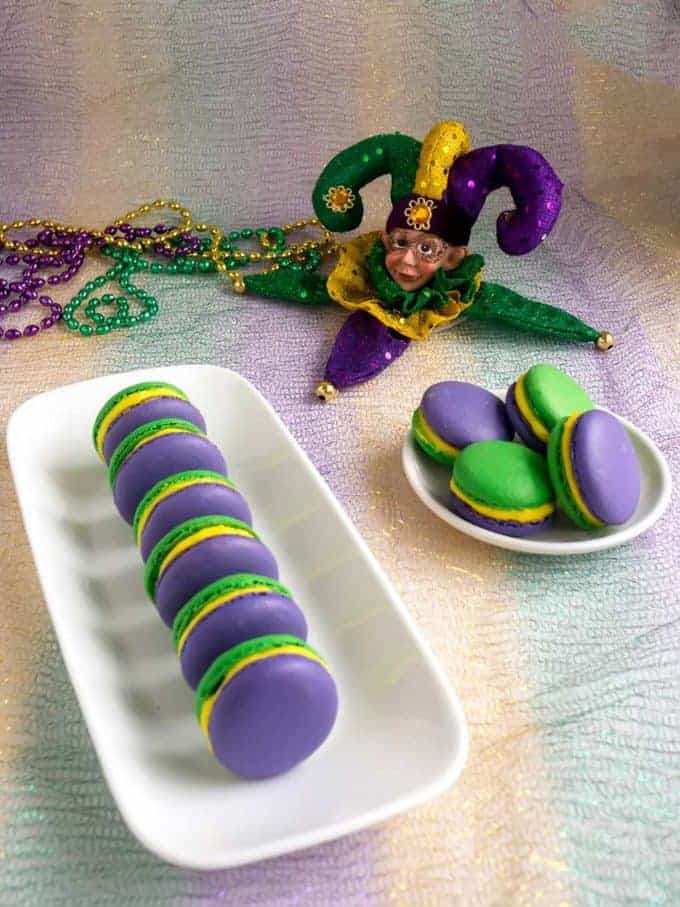 Green and Purple Mardi Gras Macaroons on a plate. 