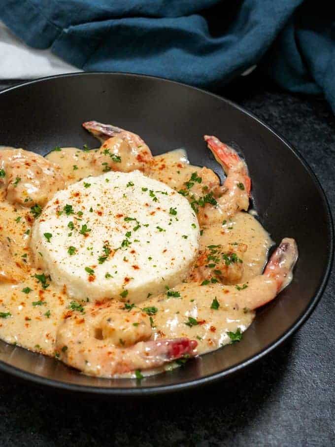 Boursin grits with shrimp cooked in a cream sauce.