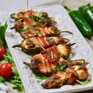 Baked Jalapeno Poppers on a white serving plate.