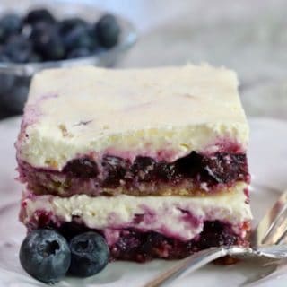 Blueberry delight on a white plate with a fork.