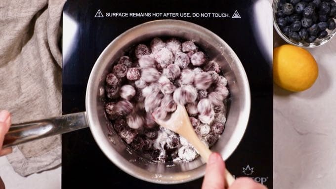 Cooking blueberries, sugar and flour in a small sauce pan. 