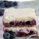 Pinterest pin for a blueberry dessert with whipped topping on a white plate.
