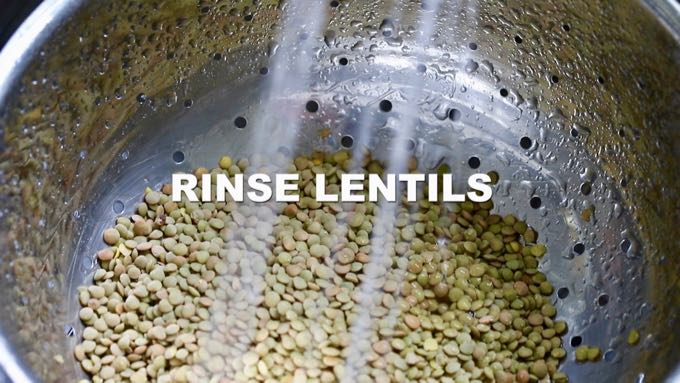 Rinsing lentils in a colander under running water.