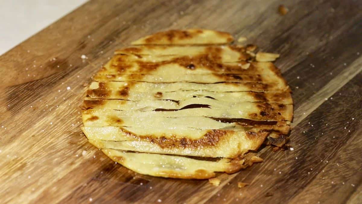 A tortilla which has been fried, cut into thin strips.