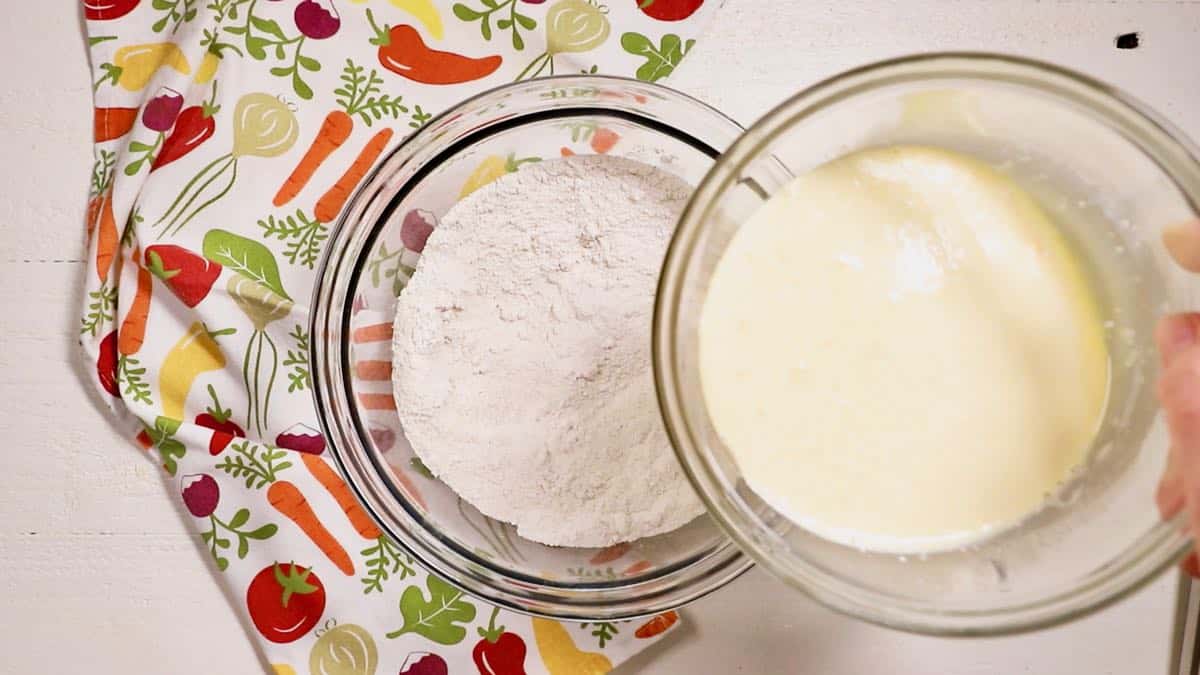 Adding eggs and buttermilk to flour mixture to make hoecakes.