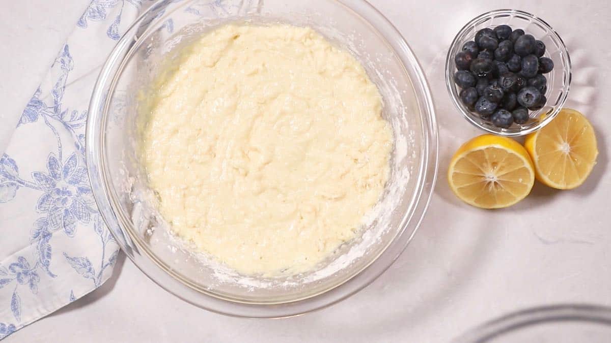 Bread batter in a clear glass mixing bowl. 