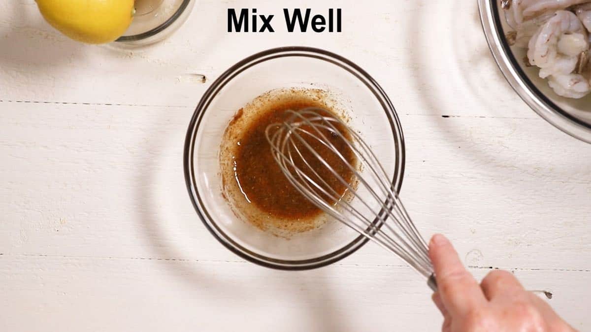 A small glass bowl with spices, olive oil, and lemon juice to make a marinade.