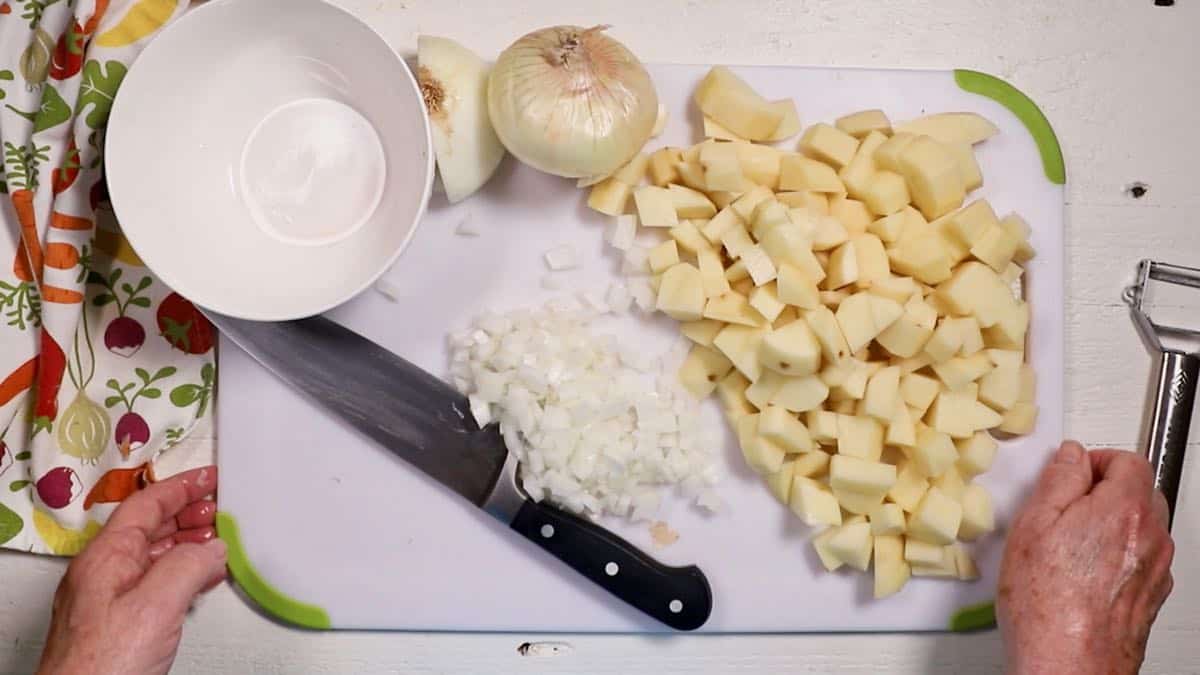 Cubed potatoes and cut up onion or a cutting board.