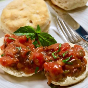 Two biscuit halves topped with tomato gravy.