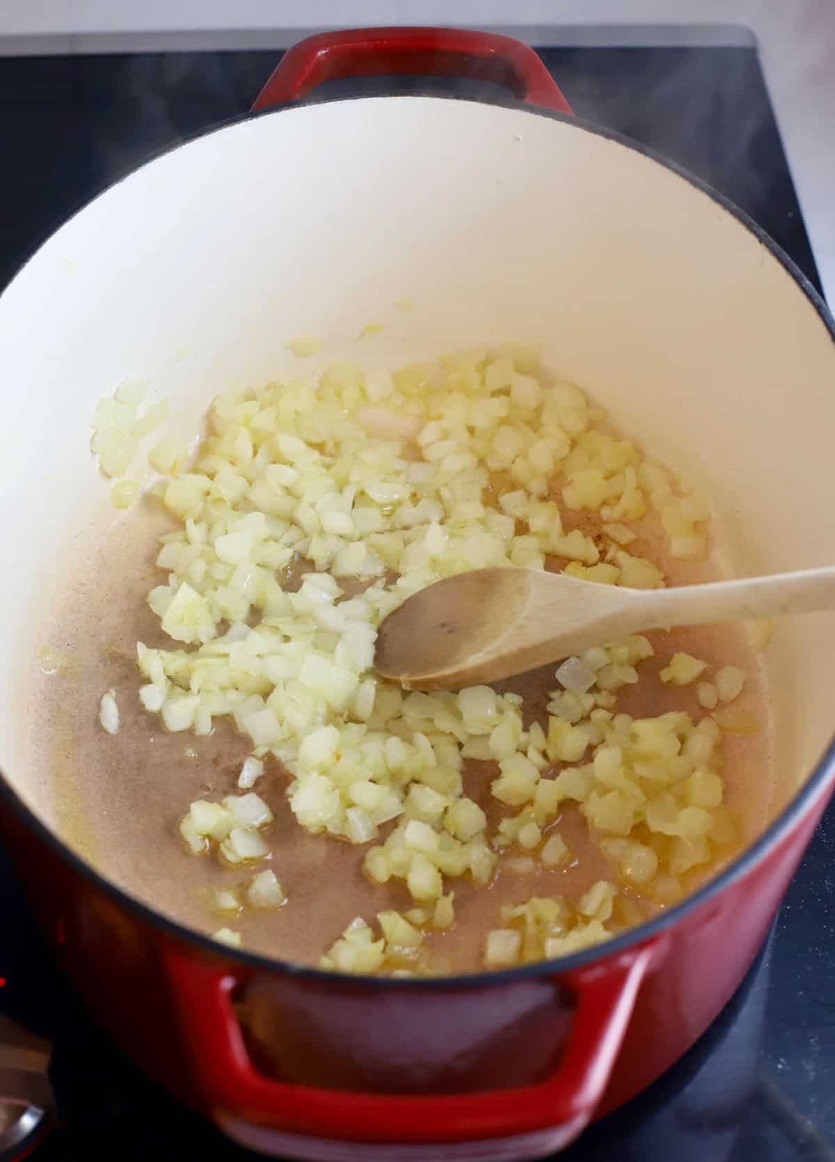 Chopped onion cooking in a dutch oven. 