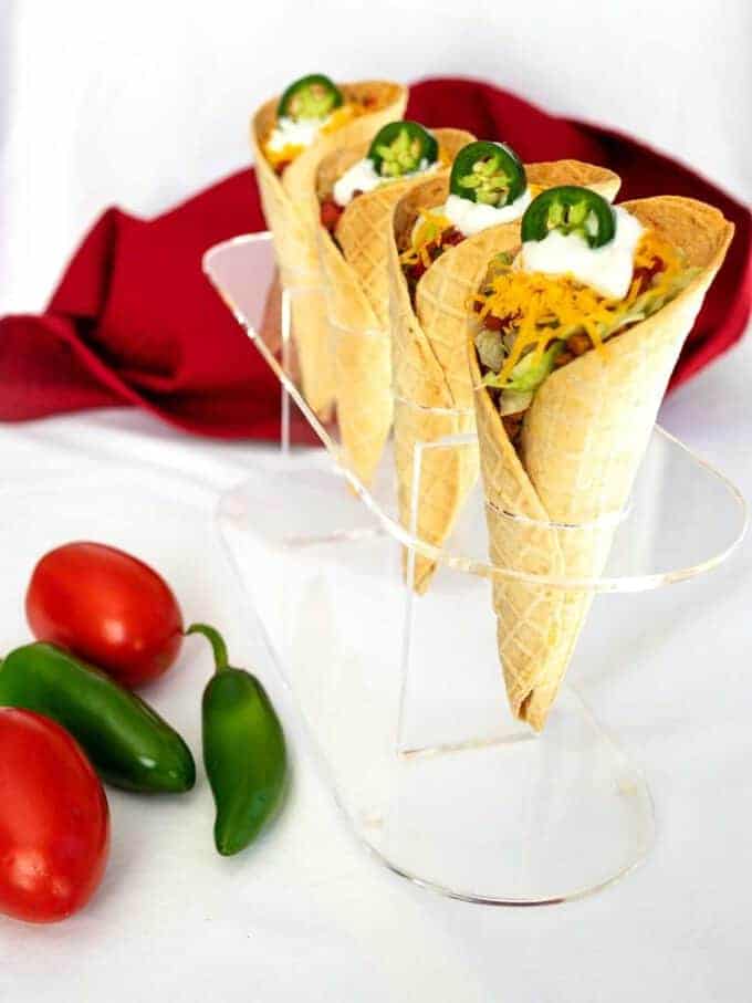 Four tacos in waffle cone taco shells. 