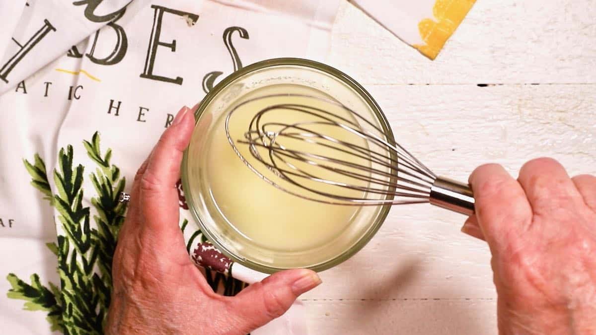 Sugar and lemon juice combined in a small glass bowl. 