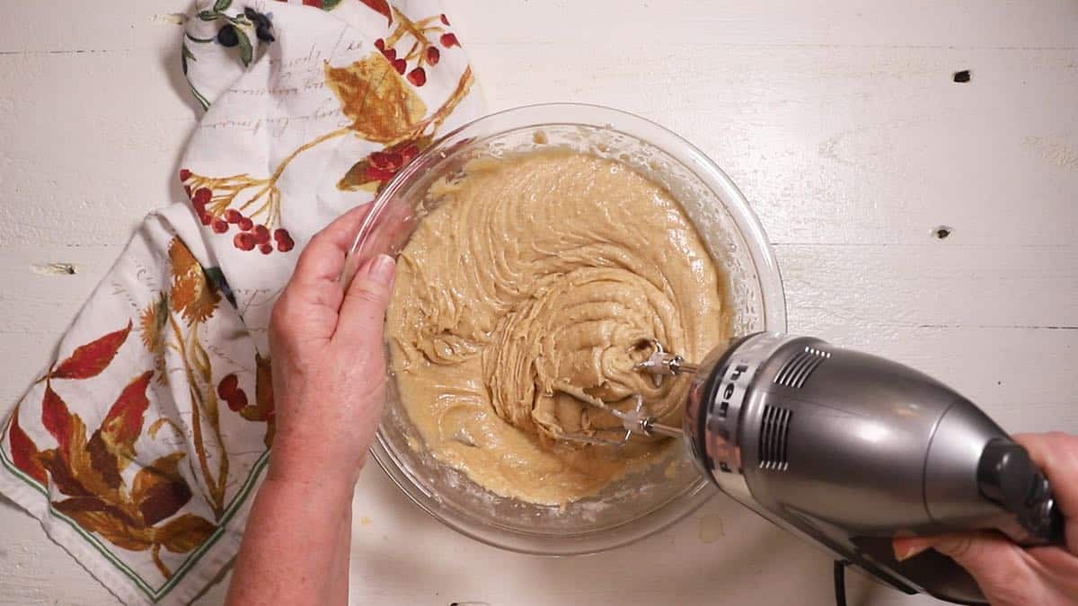 Carrot cake batter in a clear glass bowl. 