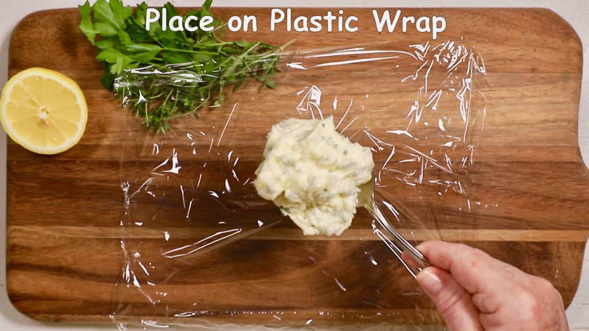 A spoonful of butter on a sheet of plastic wrap. 