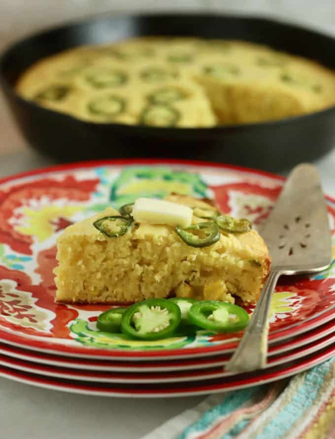 A slice of cornbread topped with jalapeno slices. 