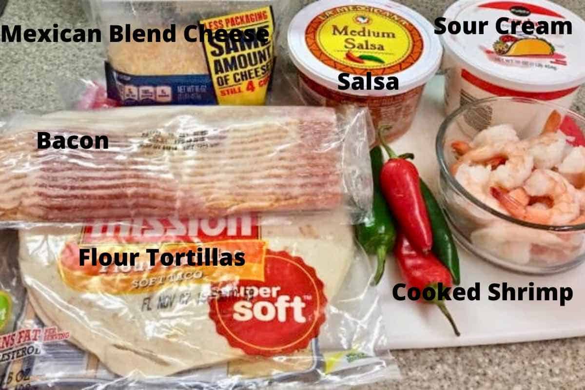 A package of bacon, frozen shrimp, shredded cheese and flour tortillas on a kitchen counter.