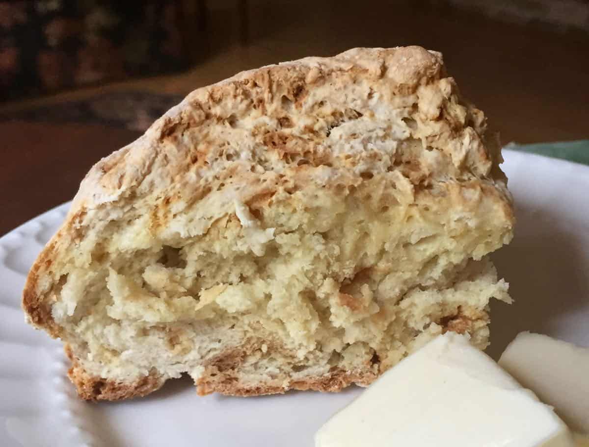 A slice of soda bread with a pat of butter.